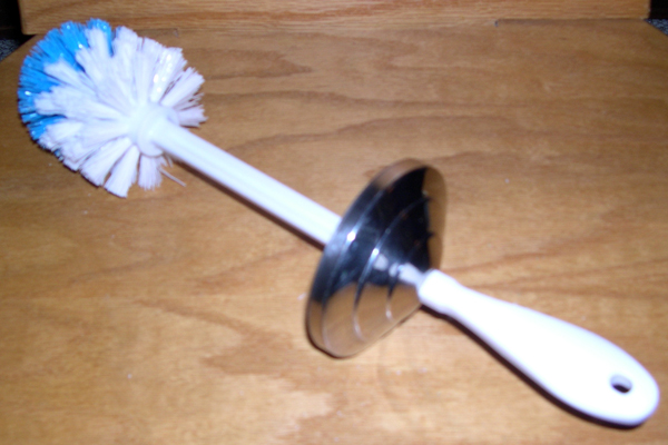 The complete brush/lid assembly.