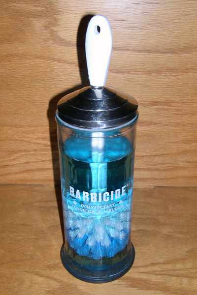 My self-disinfecting toilet brush is the bastard spawn of a regular toilet brush and a barber's disinfecting jar.
